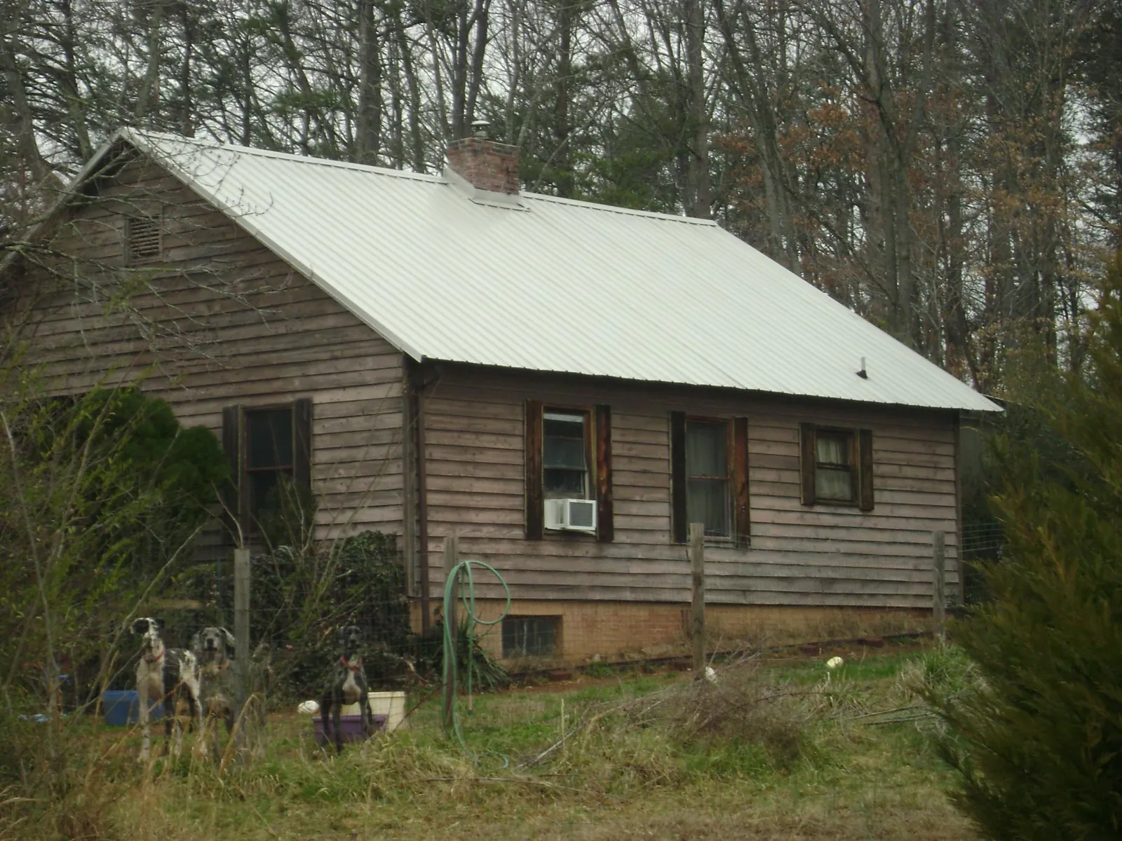 White metal roof on an old wood sided farmhouse, from a Metal Roof Installation job in Wilton